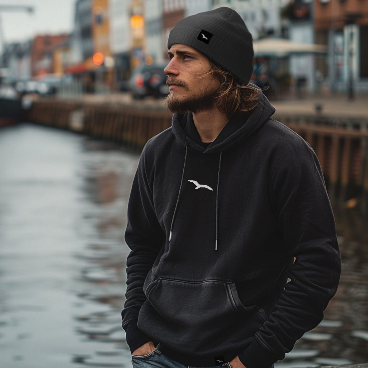 Schwarzer Worawo Hoodie mit kleinem Möwenzeichen auf der Brust – Vorderansicht am Model